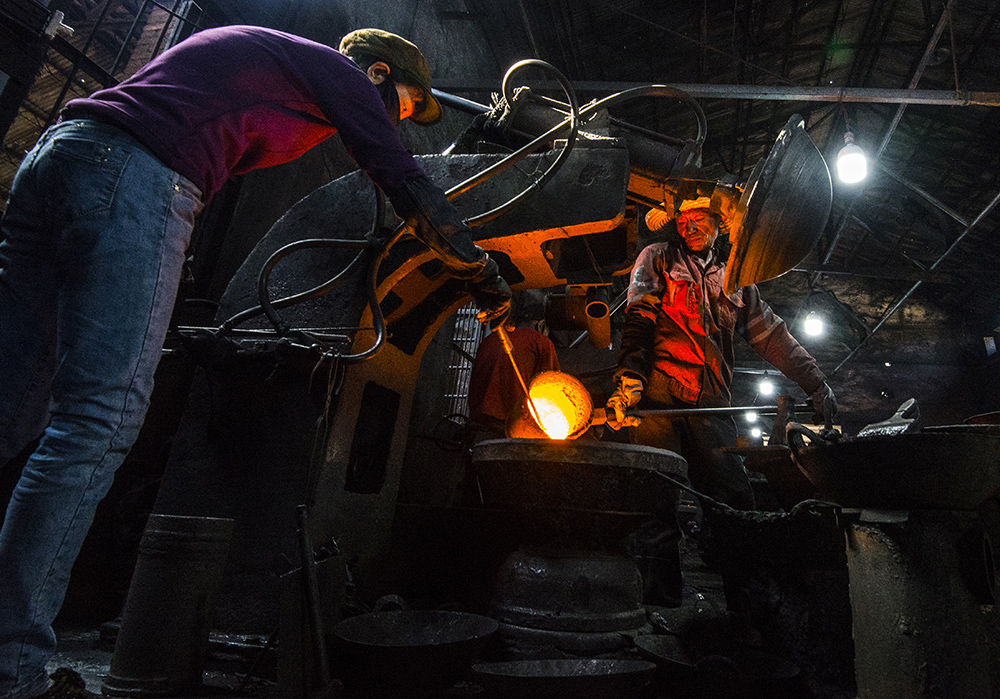 组照5:生产工人正在铸造瓜洲铁锅